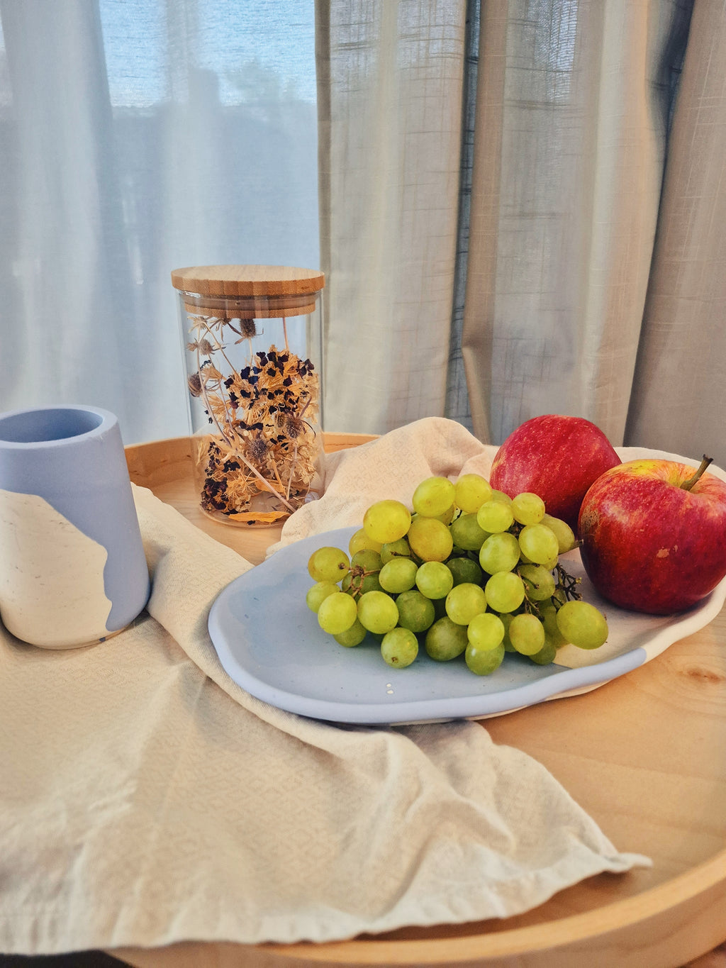 Jesmonite-Teller in Blau-Weiss mit Früchten und Accessoires dekoriert – Kollektion Waves – Maliora Designs